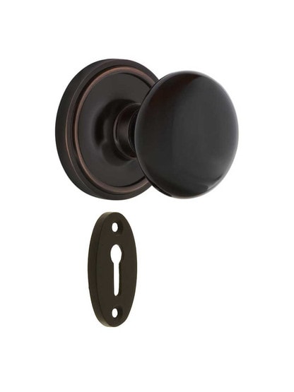 Classic Rosette Mortise-Lock Set with Black Porcelain Knobs in Timeless Bronze.